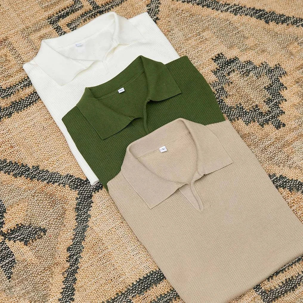 Summer v-neck polo English t-shirt in beige, green, and white laid on textured background.