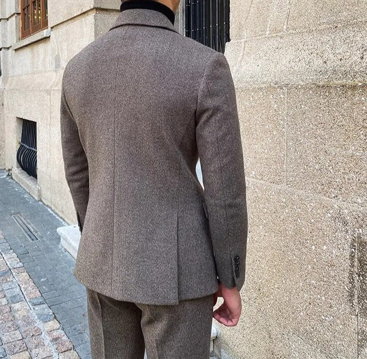 Rear view of a man wearing an elegant office double-breasted suit in a sophisticated setting.