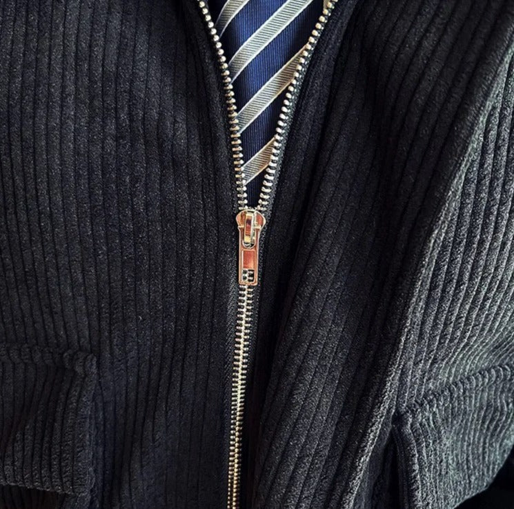 Corduroy casual jacket with zip detail, blue and gold accent-striped shirt underneath.