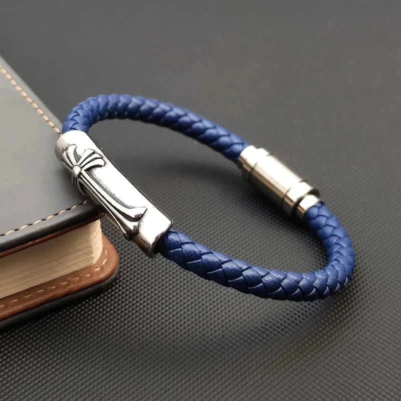 Leather bracelet with stainless steel cross on book.