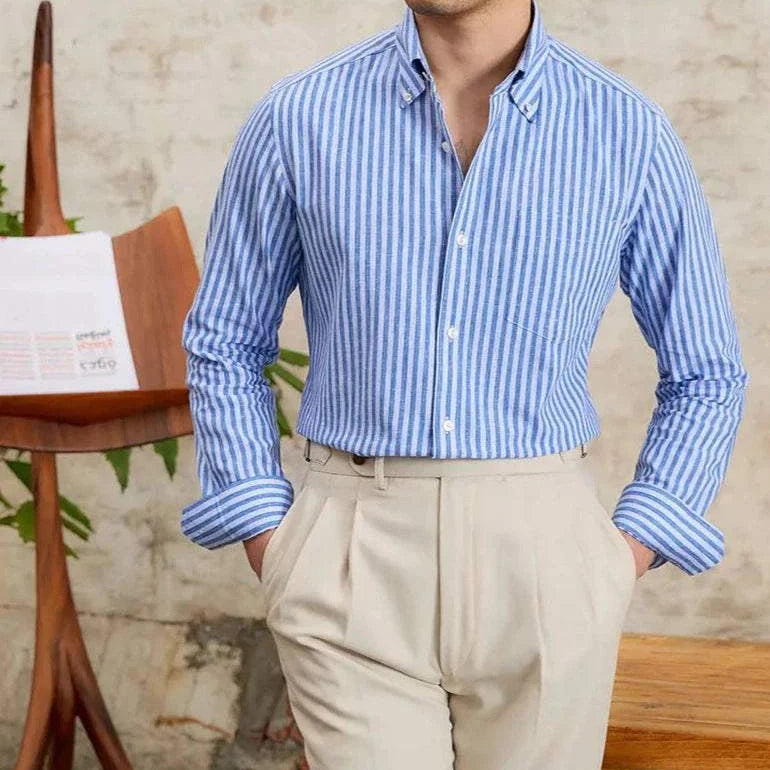 Antonios business striped long-sleeve shirt in blue and white, worn by a man, paired with beige trousers.