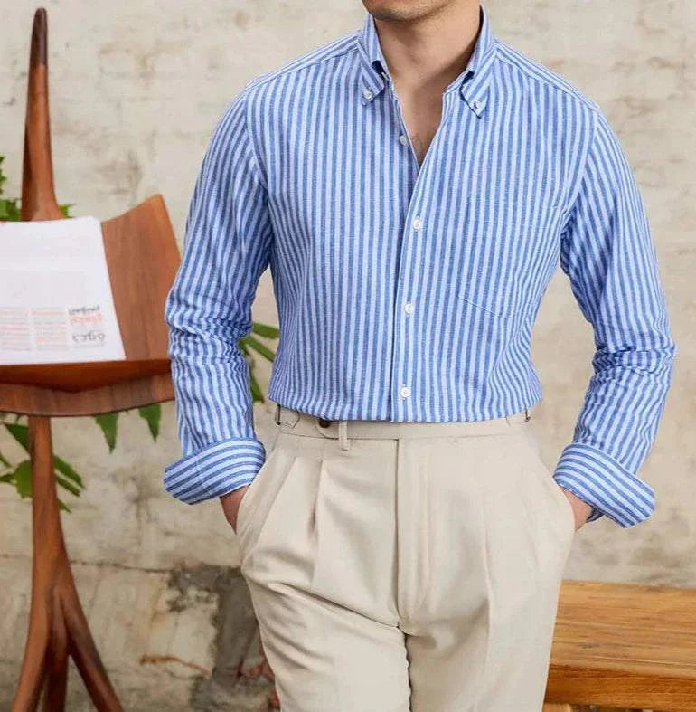 Antonios business striped long-sleeve shirt in blue and white, worn by a man, paired with beige trousers.