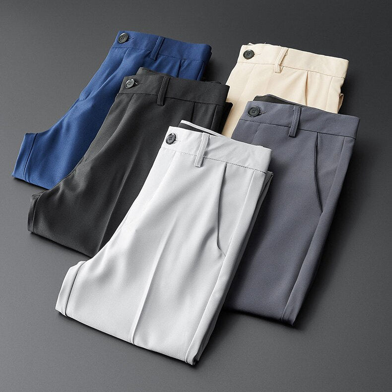 Vinny Office Pants in various colors laid out flat.