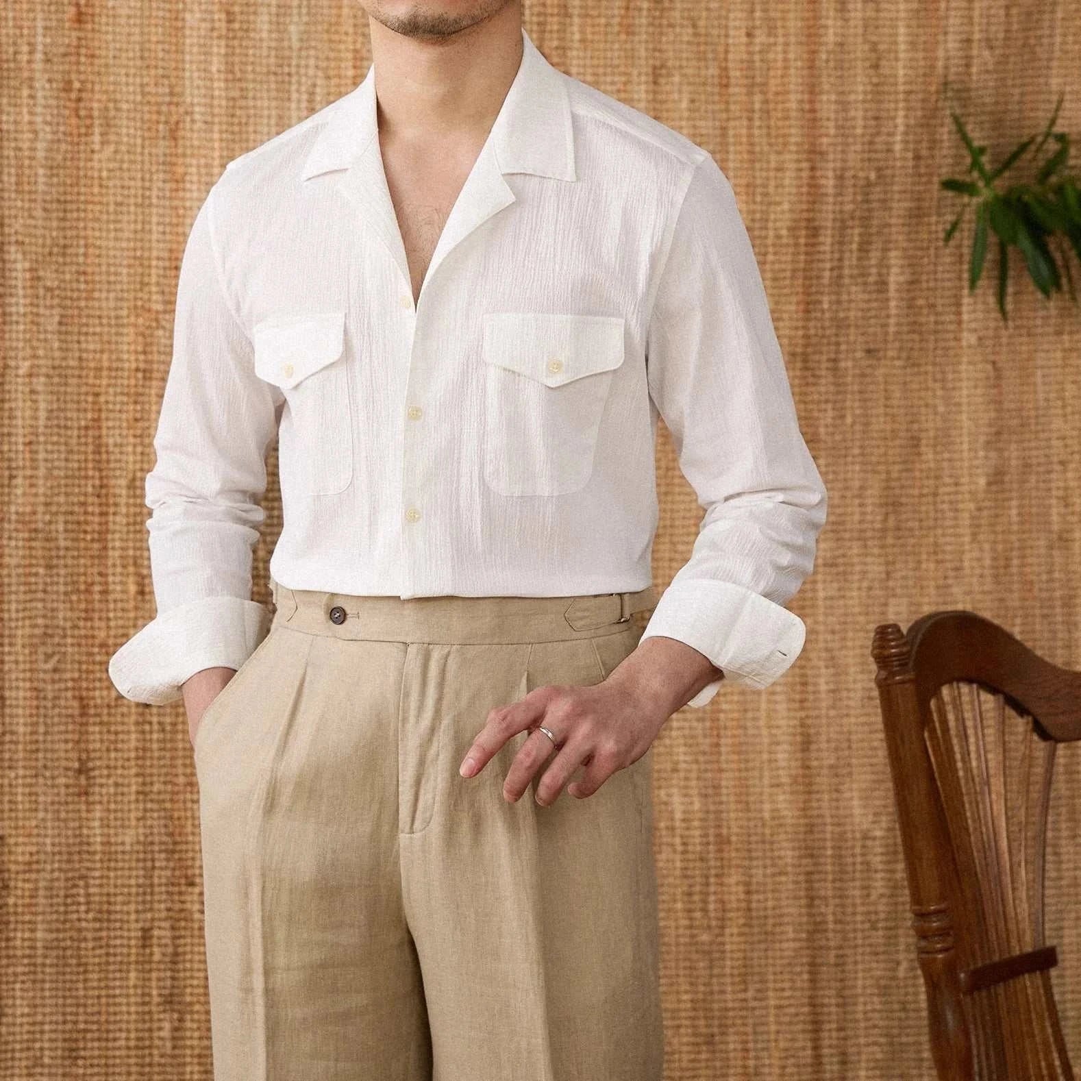 Cuban collar relaxed fit elegant shirt in white, paired with beige pants, ideal for spring and summer occasions.