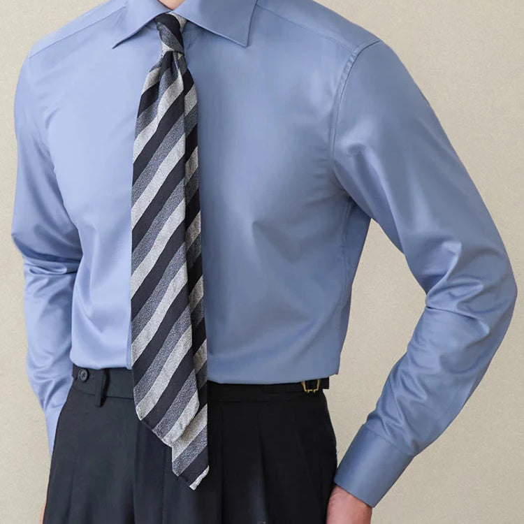 Italian style old money shirt in light blue cotton with long sleeves and striped tie.
