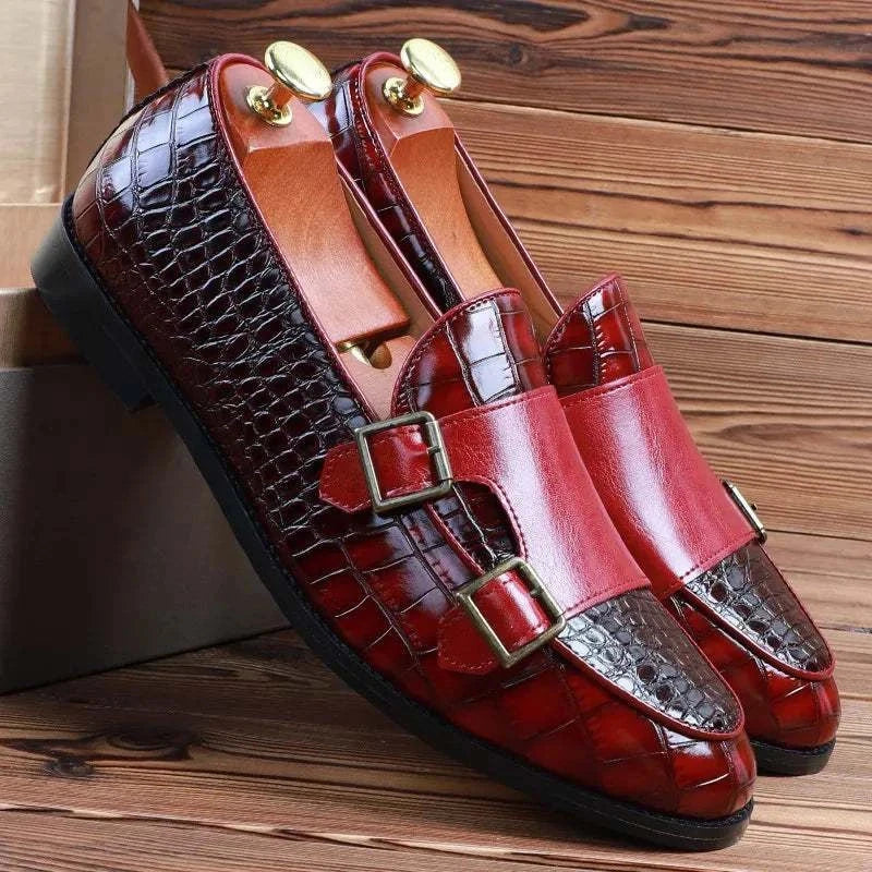 Crocodile pattern microfiber shoes with vibrant red finish on wooden background.