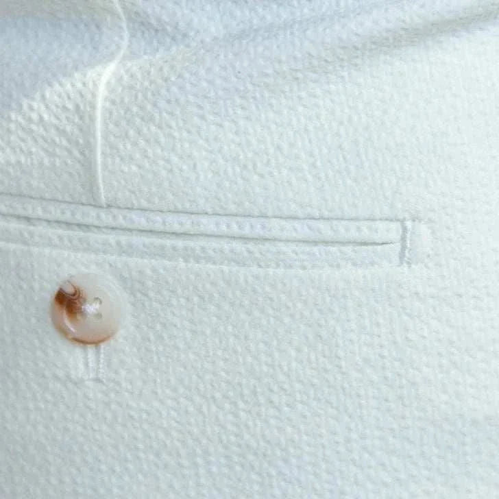 Italian design office high-waist trousers in solid white with button detail.