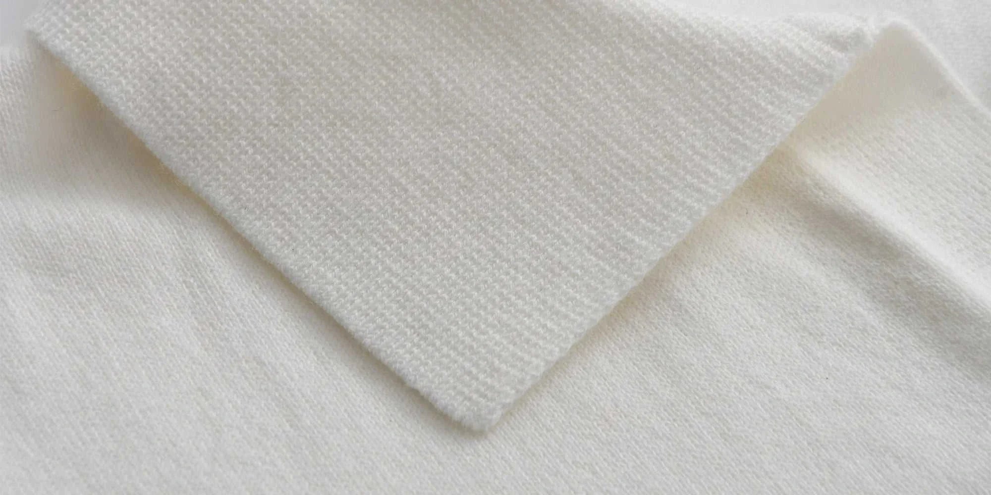 Close-up of Old Money American polo t-shirt collar, showcasing cotton texture and solid pattern.