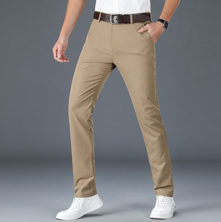 Men wearing khaki Antonios Stretch Pants and white sneakers.