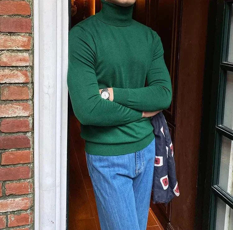 Man wearing Antonios business turtleneck sweater in green and blue jeans.