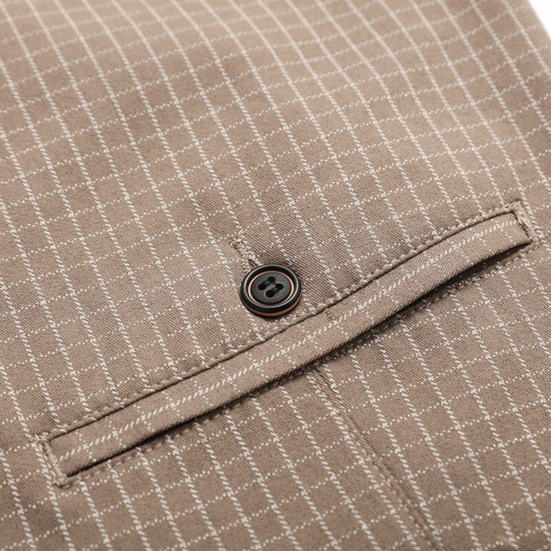 Close-up of Vinny Plaid Trousers in khaki color with pocket and button detail.