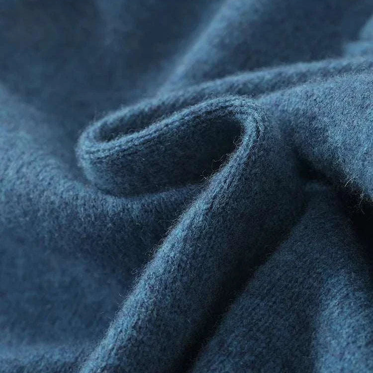 Luxury wool casual sweater fabric close-up showing texture.