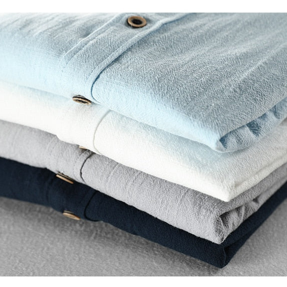 Maurice Solid Shirt in a cotton and linen blend, showcasing a stack of folded shirts in various colors.