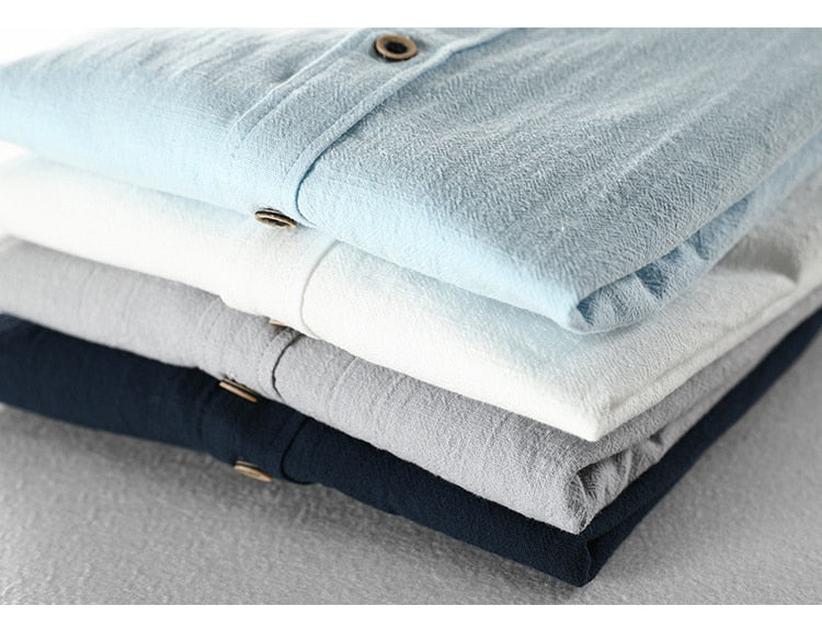 Maurice Solid Shirt in a cotton and linen blend, showcasing a stack of folded shirts in various colors.