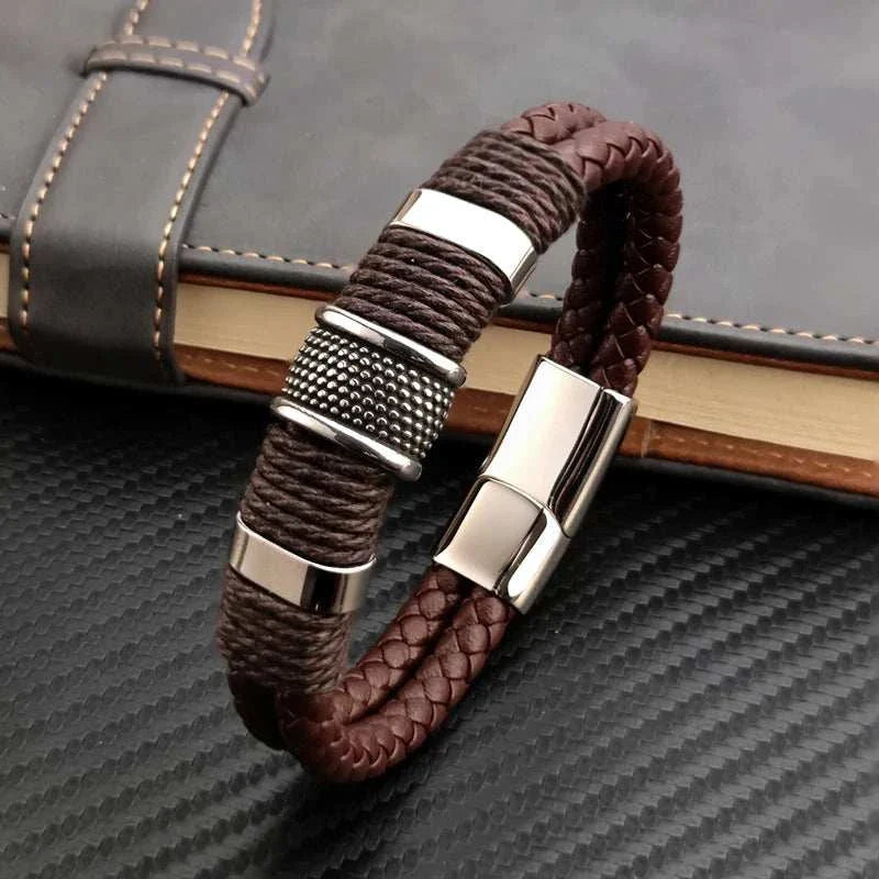Genuine leather double bracelet with stainless steel accents on a black surface.