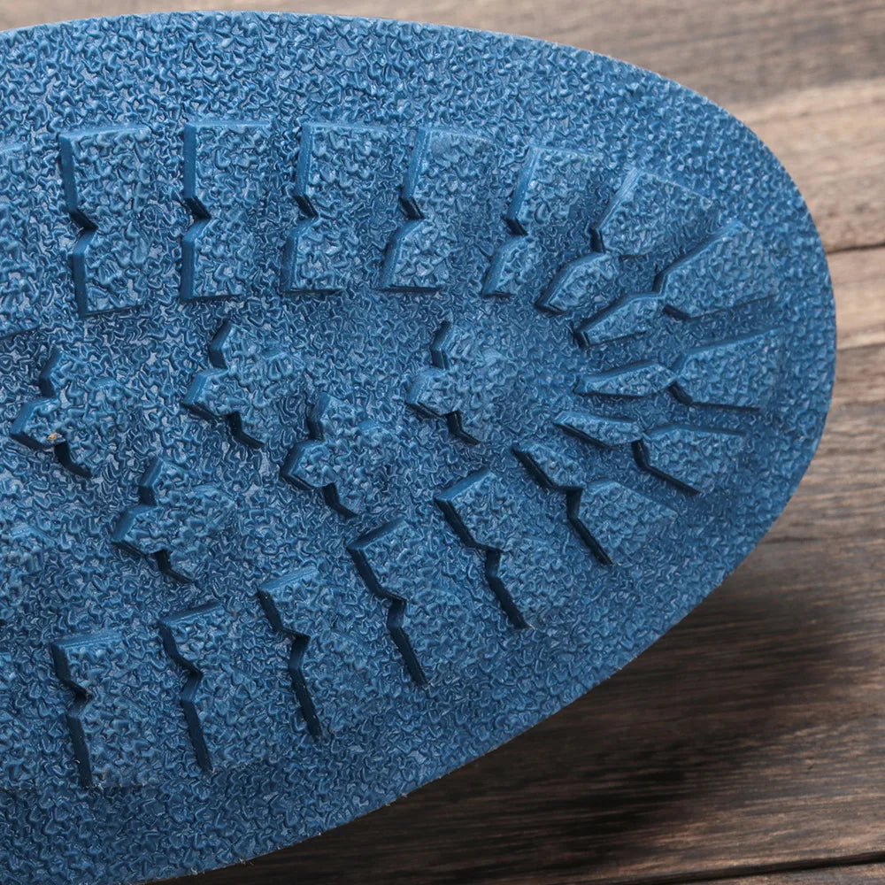 Blue rubber sole of ANT ankle boots showing traction pattern.