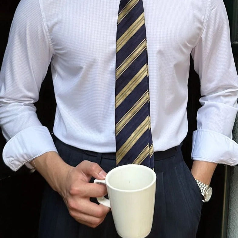 Antonios Oxford Shirt in white, styled with long sleeves and a striped tie, perfect for smart casual outfits.