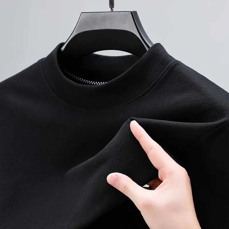 Classic black turtleneck sweater with solid pattern on hanger.