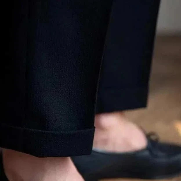 High-waist belt design trousers in black viscose with sleek finish.