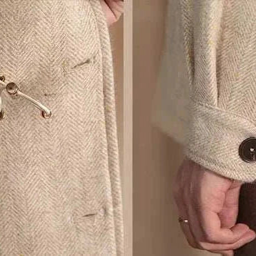 Close-up of British winter premium jacket detailing, featuring wool fabric and buttoned cuffs.