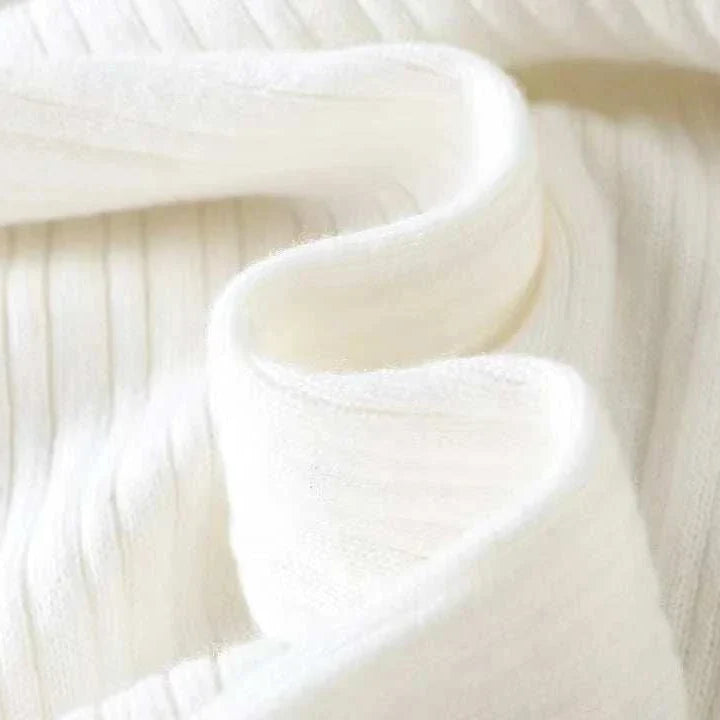 Close-up of Antonios striped jacquard knit sweater fabric in white.