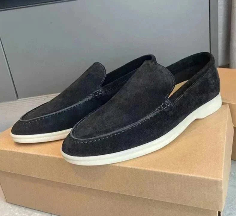 Suede elegant loafers made of sheep suede leather displayed on a box.
