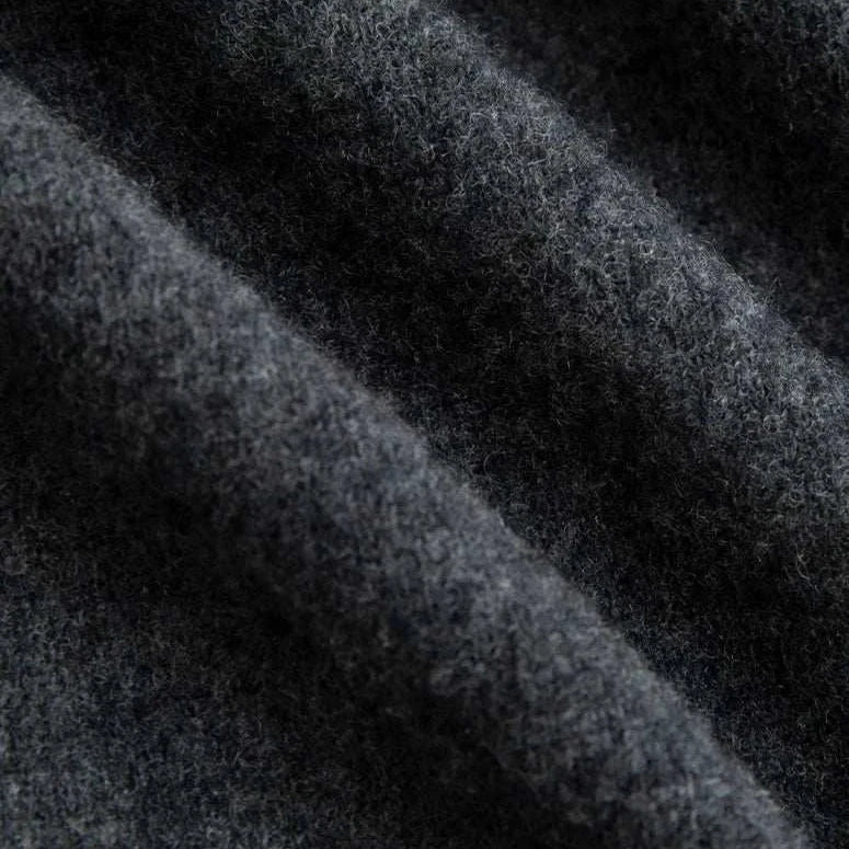 Close-up of dark wool fabric used in business turtleneck sweater.