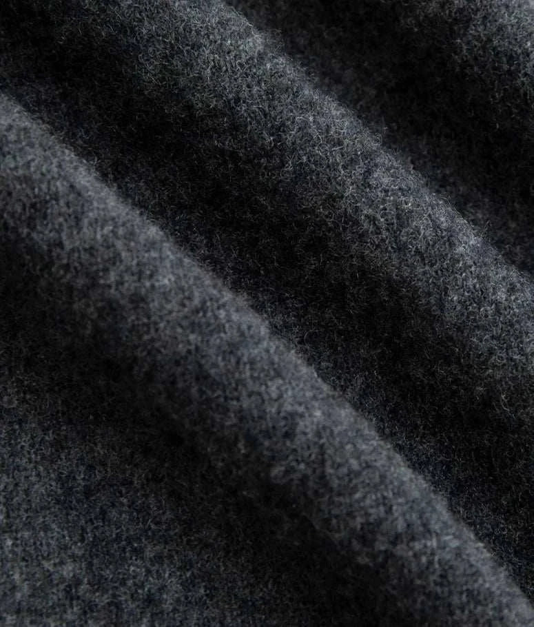 Close-up of dark wool fabric used in business turtleneck sweater.