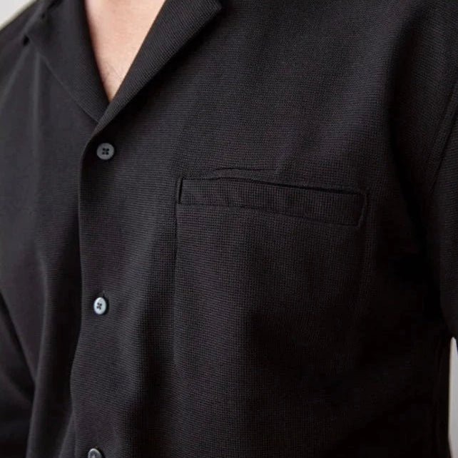Turn-down collar shirt in black with a front pocket and buttons for a smart casual look.