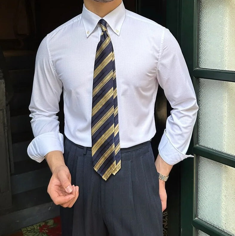 Man wearing Antonios Oxford Shirt paired with a striped tie, showcasing smart casual style.