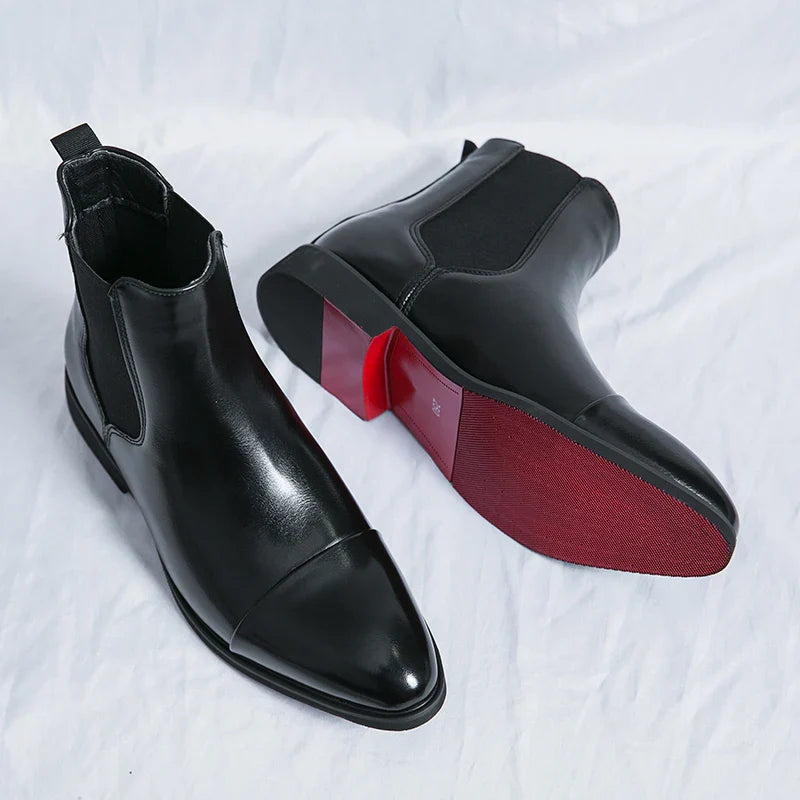 Black leather ANT chelsea boots with minimalist design and red sole.