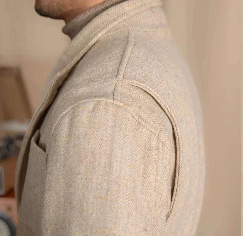 Close-up of a premium British winter jacket showcasing wool and cotton blend fabric in a neutral color.