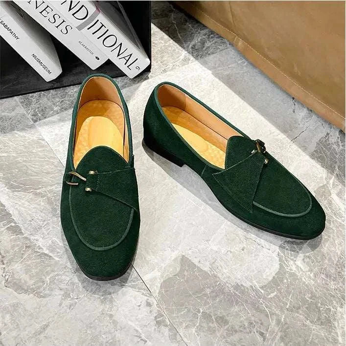 Elegant suede leather loafers in green displaying intricate craftsmanship and breathable design.