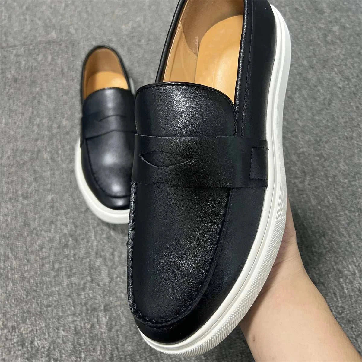 Casual slip loafers in black with white sole, featuring luxurious suede, elastic side panels, and cushioned insole.