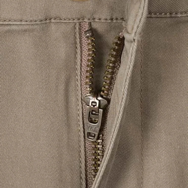 Close-up view of zipper and button detail on classic chino pants.