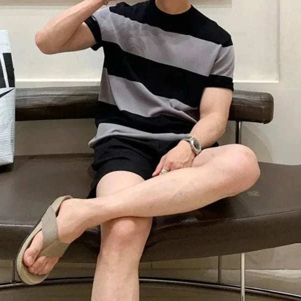 Antonios o-neck striped summer t-shirt worn by a seated model showcasing casual style.