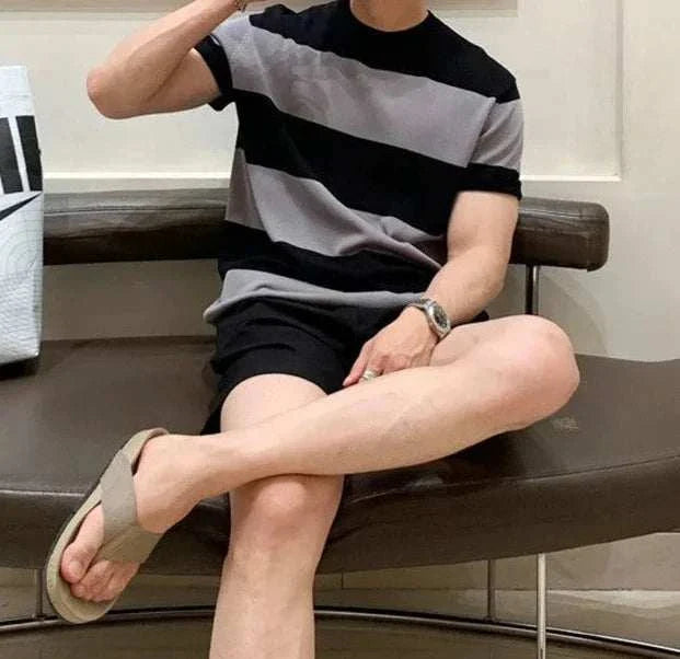 Antonios o-neck striped summer t-shirt worn by a seated model showcasing casual style.