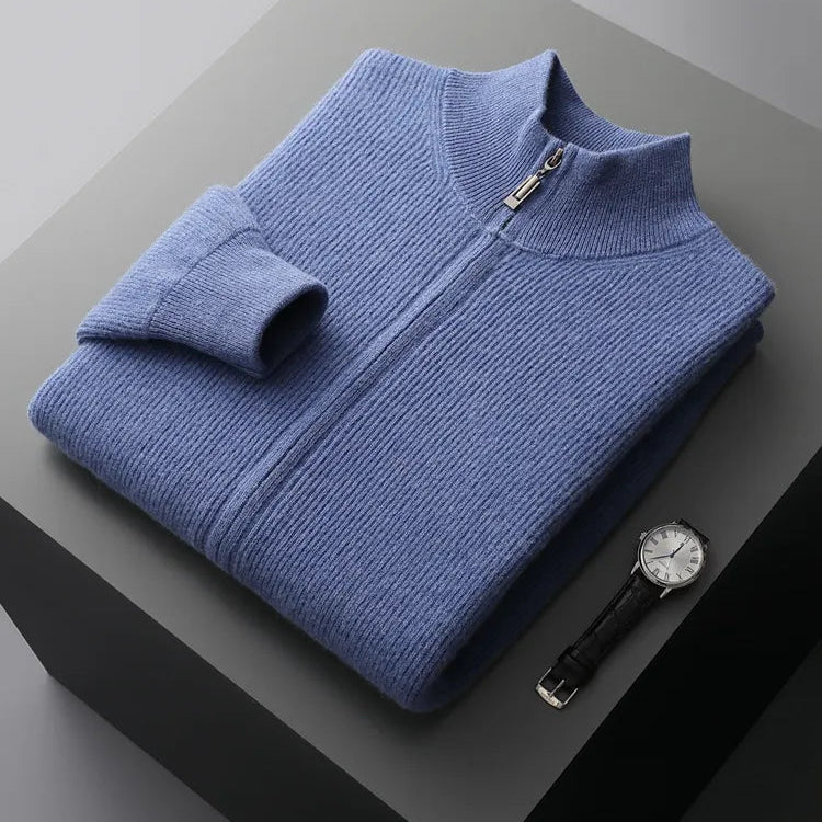 Blue pure wool cardigan on display with a folded sleeve and a watch beside it.