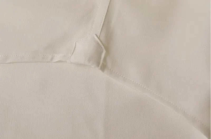 Close-up view of Antonios washed tuxedo shirt fabric showing stitching detail for stylish office wear.
