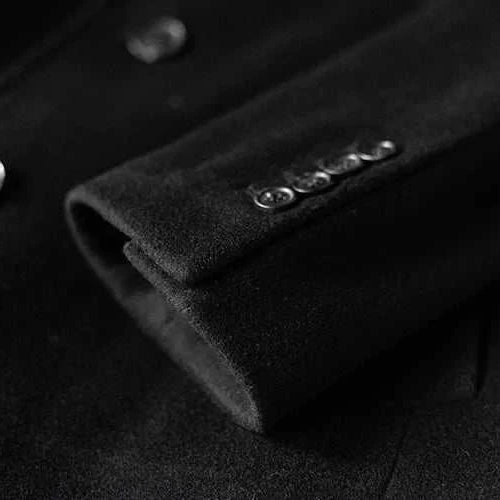 Black single breasted trench coat sleeve detail with buttons.