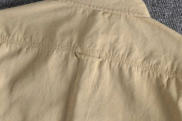 Vintage-retro cotton shirt with beige fabric and a solid pattern.