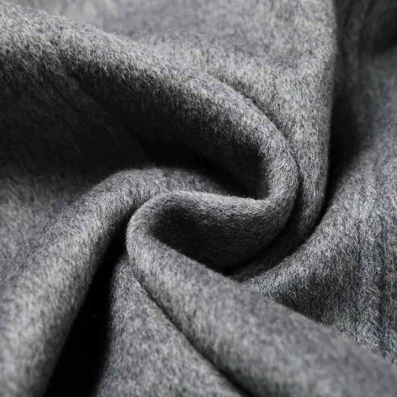 Close-up of gray wool fabric texture of an elegant long coat, perfect for autumn and winter.