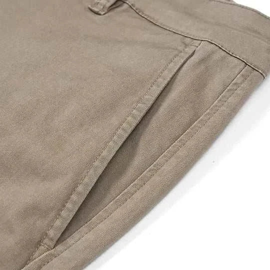Classic chino pants in beige cotton-spandex blend, side pocket detail.