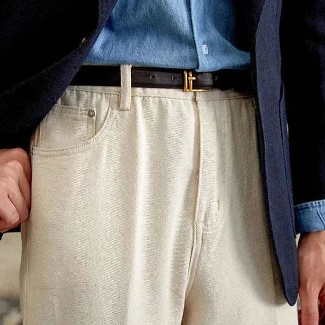 British pure cotton old money pants in cream color, worn with a blue shirt and black belt.