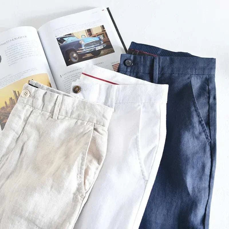 Linen straight oversize trousers in beige, white, and navy colors displayed with a magazine.