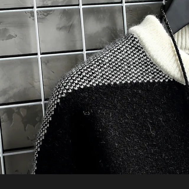 Norway sweater with elegant black and white knit pattern on hanger.