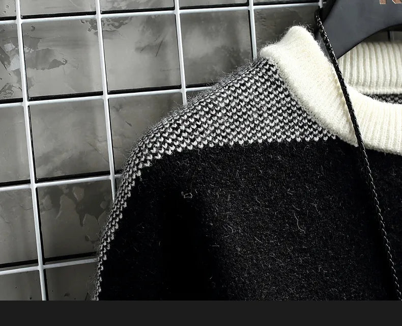 Norway sweater with elegant black and white knit pattern on hanger.