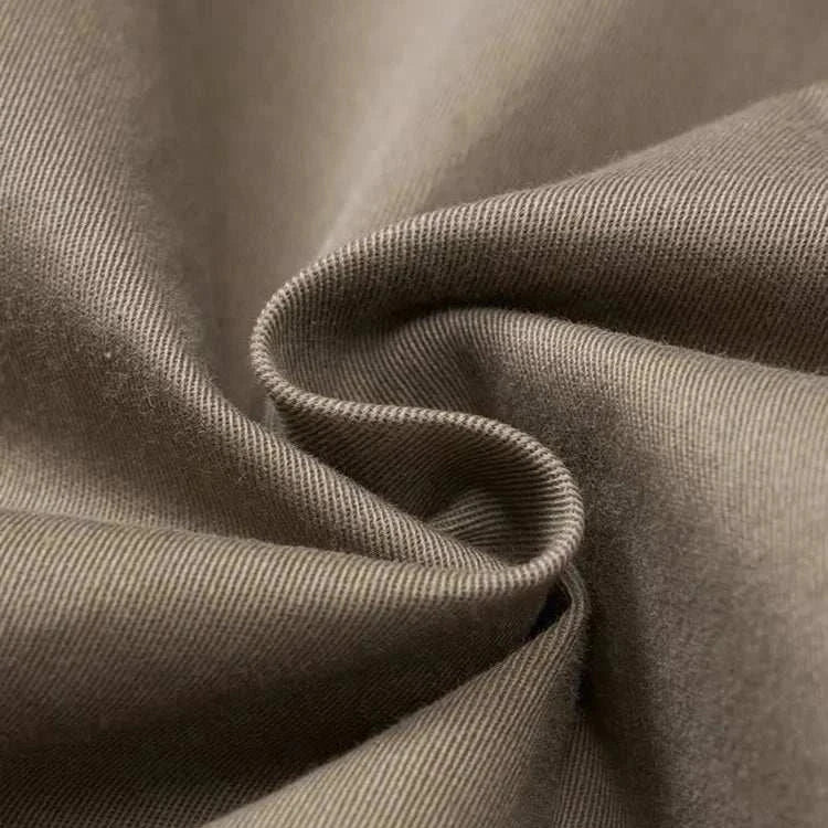 Close-up of classic chino fabric texture in neutral color.