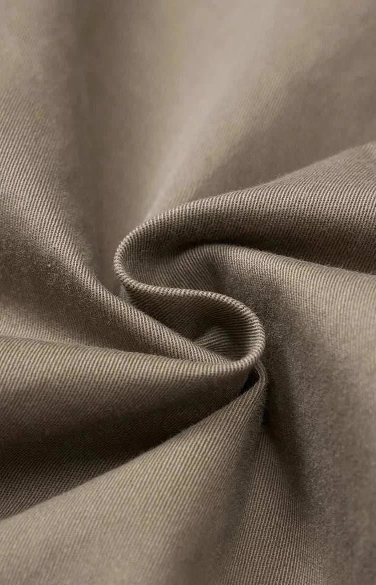 Close-up of classic chino fabric texture in neutral color.