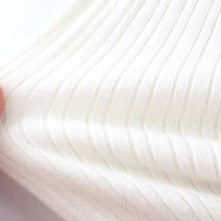 Close-up of Antonios striped jacquard knit sweater fabric in white, showcasing its texture and knit pattern.